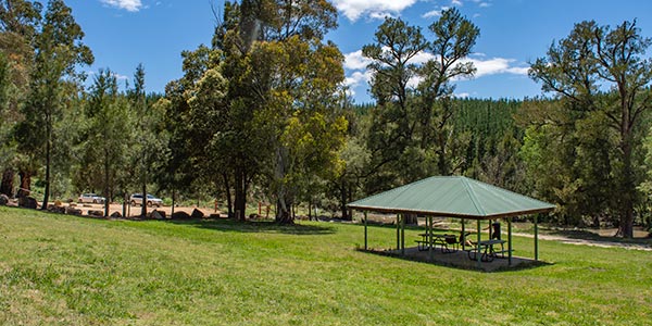 Picnic shelter with carpark and river in background.