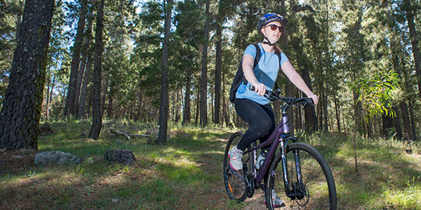 Woman riding a bicycle at Isaacs Pines