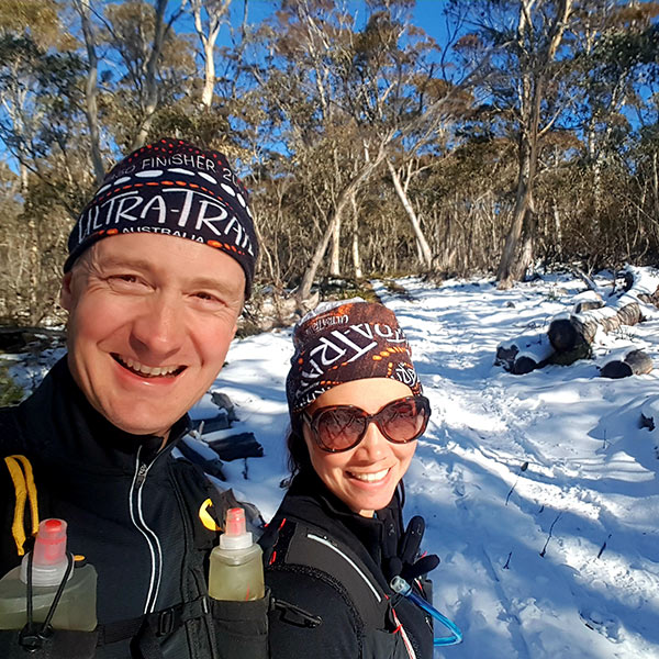 Man and woman hiking in snow in Namadgi National Park